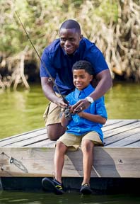father and sun fishing on dock