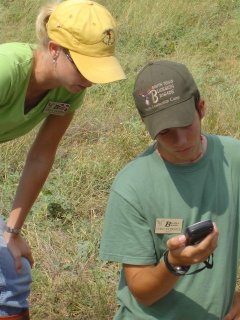 Two youths reading a handheld device. Two youths reading a handheld device.