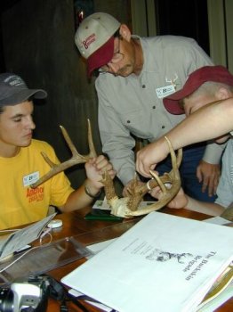 Two youths scoring antlers while being observed by instructor. Two youths scoring antlers while being observed by instructor.