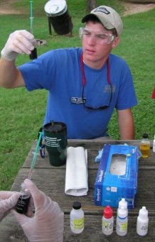 Youth testing water quality. Youth testing water quality.