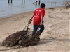 Volunteer Dragging Abandoned Crab Traps Onto Beach, San Antonio Bay, 2-19-11