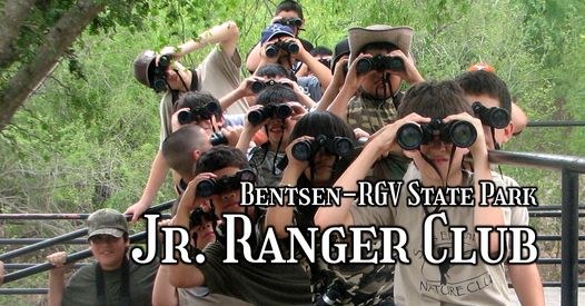 Photo of a group of junior ranger kids looking through binoculars in the park.