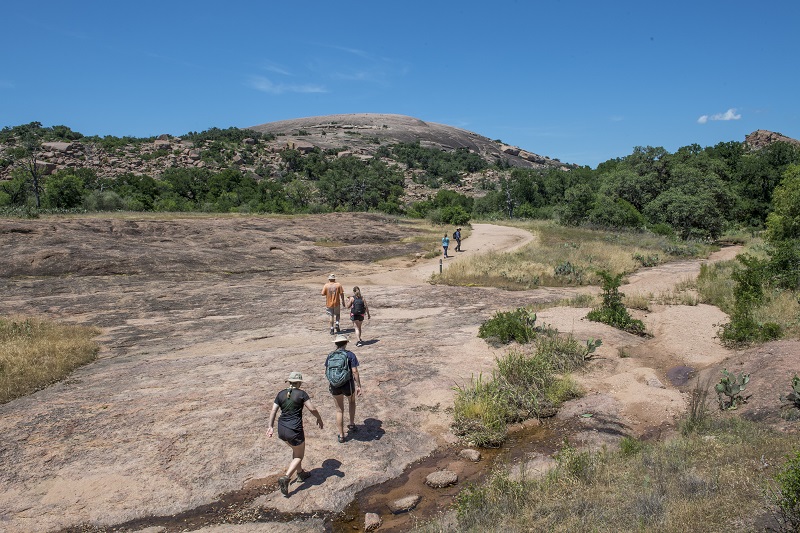 People Hiking Enchanted Rock Summit Trail