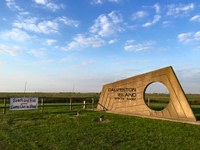 galveston island state park entrance sign with prairie in background