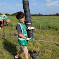 kid carrying garden pots