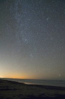 beach at night with stars shining above