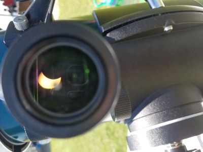 View of solar eclipse through a telescope lens
