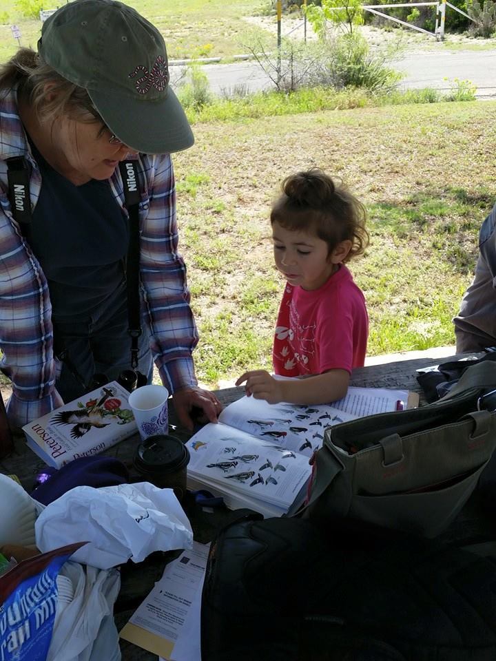 Kirsti and Sibley looking up a bird they found during a  Big Sit at Lake Colorado City State Park