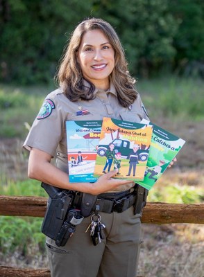 Joann Garza-Mayberry Poses with her Children's Books at Lockhart State Park