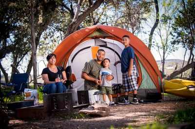 Family posed in front of small tent