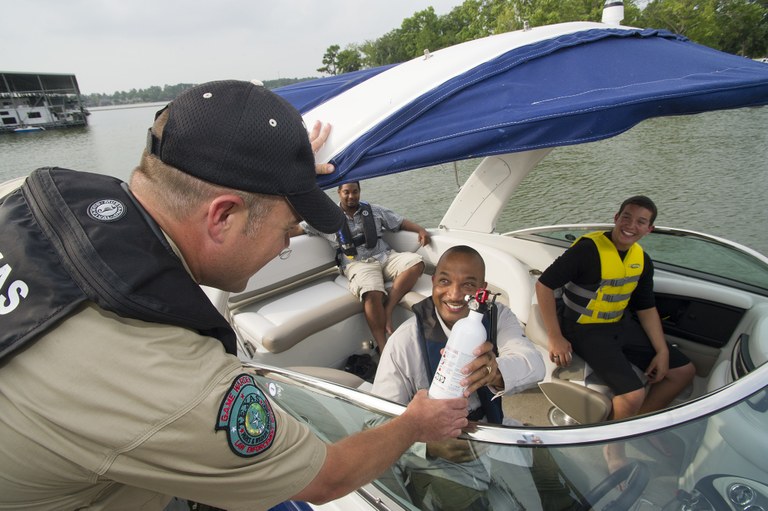 Game Warden does a boating safety check 