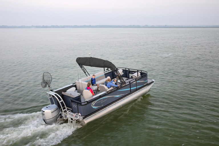 Family driving a pontoon boat with fishing poles 