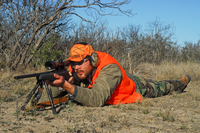 shooter using a bipod rifle support in prone position