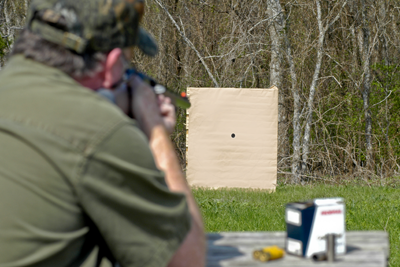 aiming shotgun at paper target