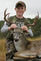 Young hunter with his deer harvest