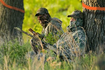 hunters in camo calling turkey