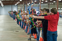 row of young archers drawing bows