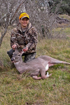 Hunter posing with harvested deer