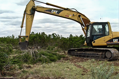 Brush clearing with backhoe