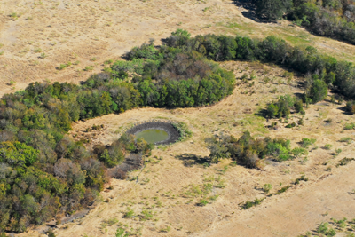 Another aerial view of land, woods and water