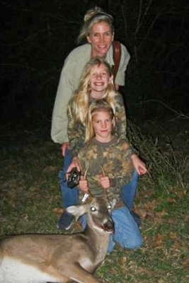 mom and daughters with harvested deer