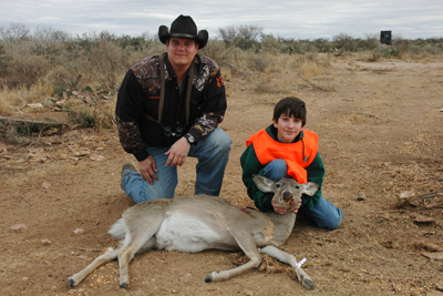 Youth Hunter and adult with deer
