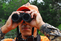 hunter peering through binoculars