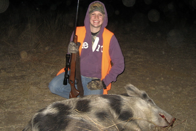 Hunter poses with harvested feral hog