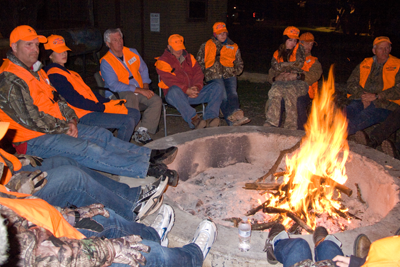 Youth hunters around a campfire
