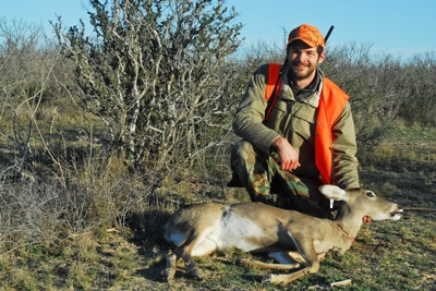 Hunter poses with harvested deer