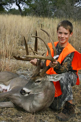 Young hunter with harvested buck