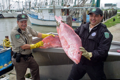 Game Wardens with confiscated fish taken illegally