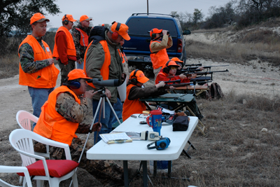 Adults supervising youth hunters target practice