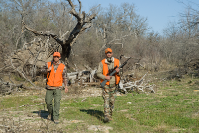 hunters walking in field