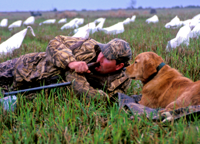 waterfowl hunter with his dog