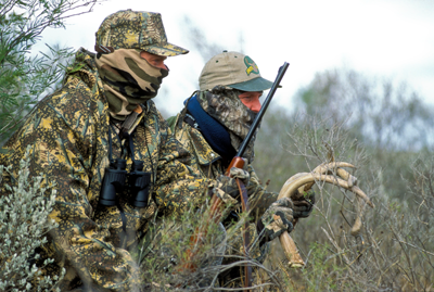 camoflaged hunters rattling antlers