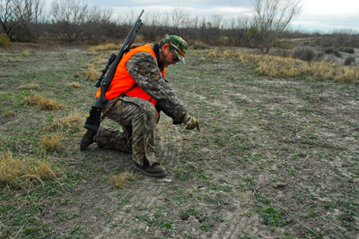 Hunter looking for sign of prey on ground