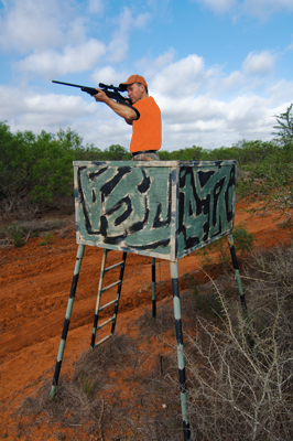 Hunter shooting from open tower blind