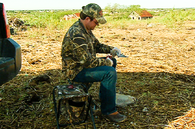 hunter cleaning harvested dove