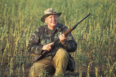 Dove hunter seated wearing hat