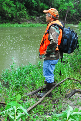 Hunter surveying creek bank for crossing