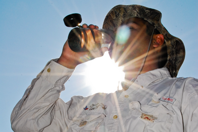 Hunter drinking water in hot sun