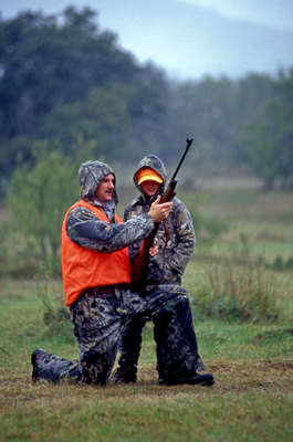 Man and boy in hunting apparel