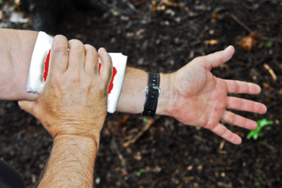 Applying pressure to arm wound