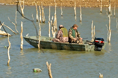 Hunters sitting towards back of boat