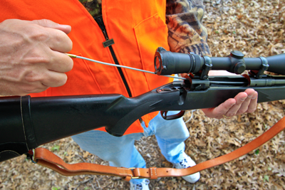 hunter clearing obstruction from rifle barrel