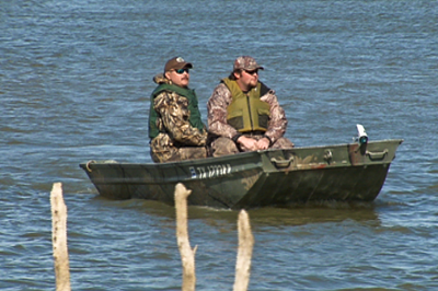 hunters in boat wearing PFD's