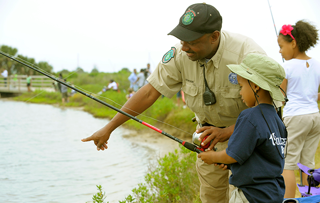 Instructor teaching kids how to fish