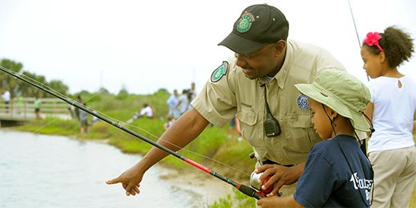 Instructor teaching kids how to fish