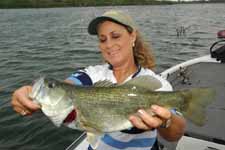 female angler with largemouth bass